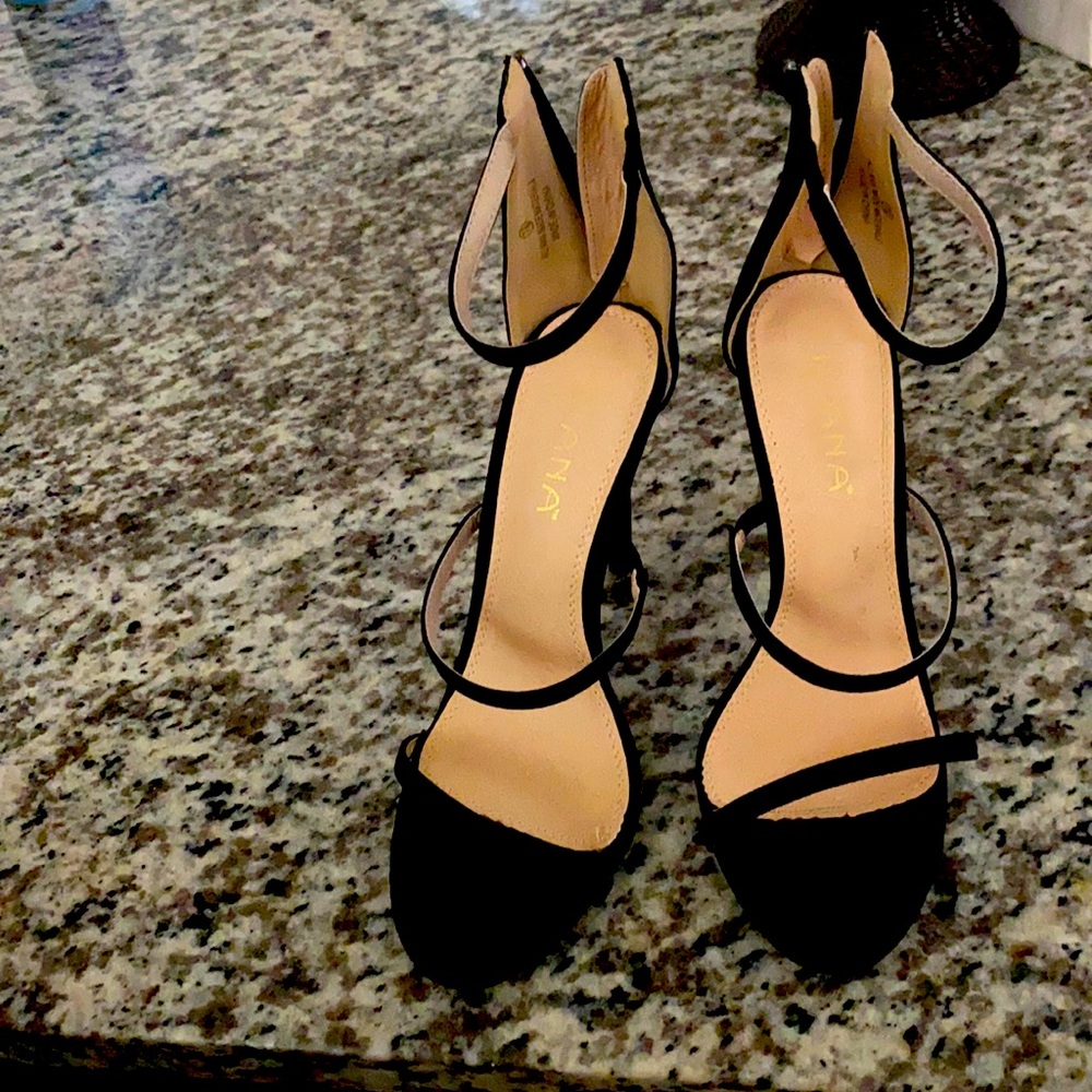Black heels with three straps.
